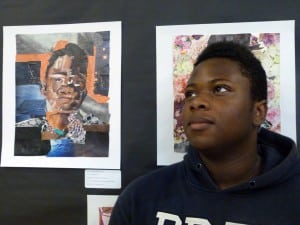 Ramon Henderson-Best stands by his self portrait at Riis Settlement's Spring Arts Festival 2014